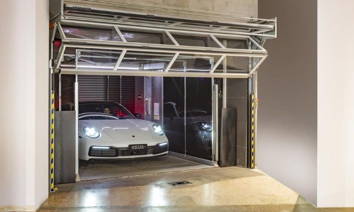 Porsche fährt aus dem Autolift das mit Compact Toren verschlossen wird