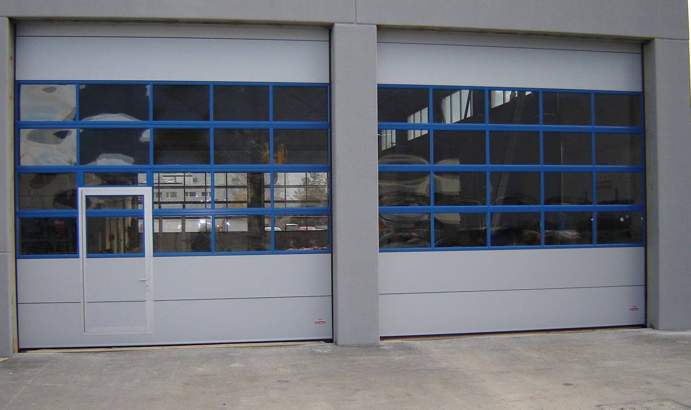 Wicket door in a Compact door with blue frames around the glazing