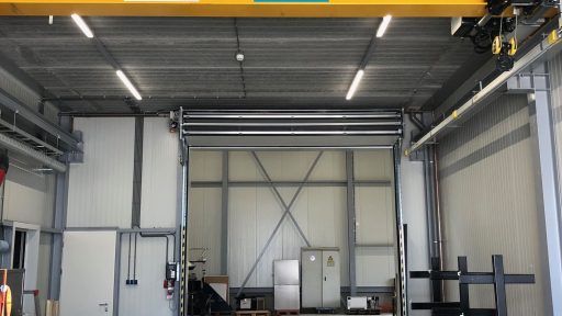 Compact industrial door with crane track