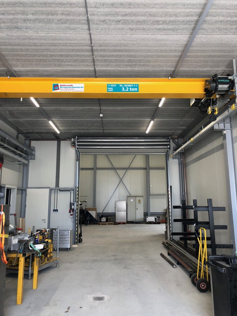 Compact industrial door with crane track