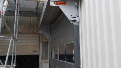 External mounted Compact doors with wicket door and storm profiles at Fermacell